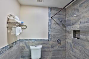 a bathroom with a toilet and a shower at Monterrey Motel Padre Island, Corpus Christi BY OYO in Padre Island