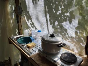 a pot sitting on top of a stove in a tent at La Ramie in Marat +29 photos