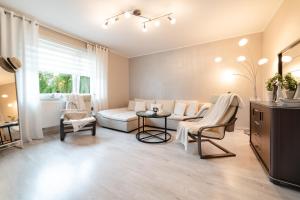 a living room with a couch and a table at Wenge in Jastarnia +18 photos