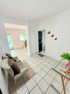 a living room with a chair and a table at casa em jacumã in Conde