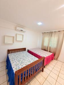 a bedroom with two beds and a window at casa em jacumã in Conde