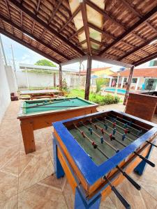 a pool table sitting on top of a patio at casa em jacumã in Conde