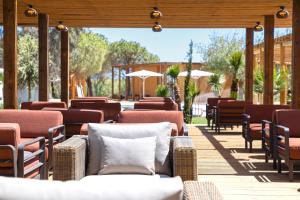 a row of chairs and tables on a patio at OZADI Altura Beach Resort - Eurotel Altura in Altura