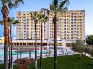 a view of a hotel with palm trees and a pool at OZADI Altura Beach Resort - Eurotel Altura in Altura