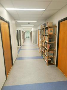a hallway of a library with bookshelves at Office House Tripla in Helsinki