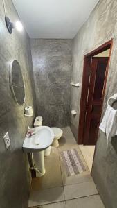 a bathroom with a white sink and a toilet at Pousada em Paracuru Casa Eco Kite Surf & Relax in Paracuru +49 photos