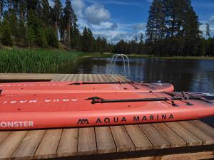 a red boat sitting on top of a dock at AVOTUPJi in Plānupe