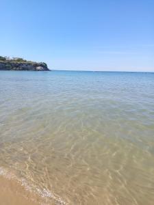 a body of water with a sandy beach at Riflessi nosTrani - Seaside Rooms in Trani