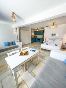 a living room with a table and a couch at White Blue Houses & Apartments Paros in Parikia