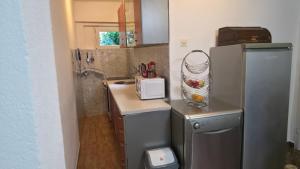 a small kitchen with a sink and a refrigerator at Apartments MiMa in Kotor