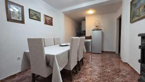 a dining room with a table and chairs and a refrigerator at Apartments MiMa in Kotor