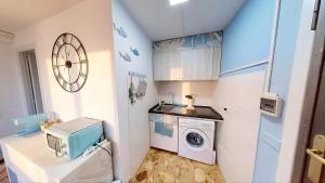 a laundry room with a washer and dryer at Casa vacanza 'Note di mare' in Torvaianica