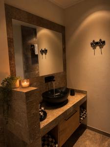 a bathroom with a sink and a mirror at Erftlodges L1 in Bad Münstereifel