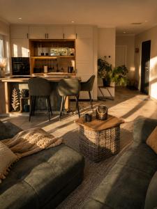 a living room with a couch and a table at Erftlodges L1 in Bad Münstereifel