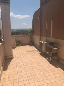 an outdoor patio with a grill on the side of a building at Casavacanze da Mari in Tivoli Terme