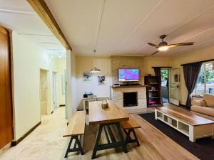a living room with a table and a couch at Pleasance Flat nr 8A Worcester Street in Grahamstown