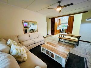 a living room with a couch and a coffee table at Pleasance Flat nr 8A Worcester Street in Grahamstown