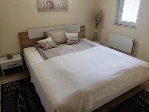 a bedroom with a large bed with white sheets and pillows at Apartma Dečko Rogaška in Rogaška Slatina