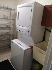 a white dryer sitting on top of a refrigerator at Cozy in London