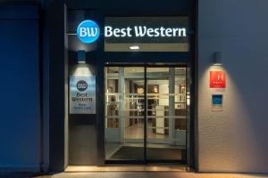 a blue building with a bus best western sign on it at Best Western Dijon Centre Gare in Dijon