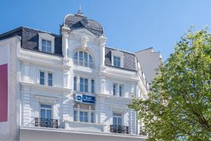 a white building with a black roof at Best Western Dijon Centre Gare in Dijon +38 photos