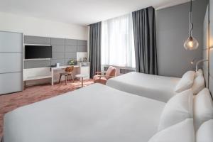 a hotel room with two beds and a desk at Best Western Dijon Centre Gare in Dijon