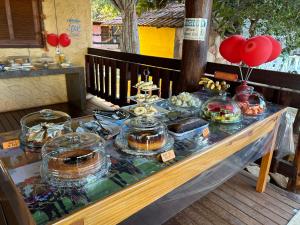 a buffet of food on a table with balloons at Pousada Recanto Guará Oficial in Pirenópolis