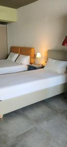 two beds sitting next to each other in a room at Nicole's Cave Studio in Pylos
