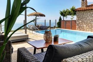 a patio with a pool and a table and chairs at Georgia Villas in Drymon