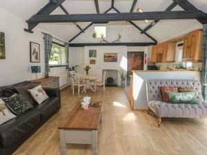 a living room with a couch and a table at Daffodil Cottage in Treorky
