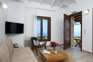 a living room with a couch and a table at Georgia Villas in Drymon