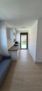 a kitchen with a long hallway leading to a door at Studio between city and countryside in Lompret