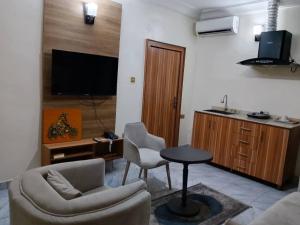 a living room with a couch and a table and chairs at Marrisson Residence in Abuja