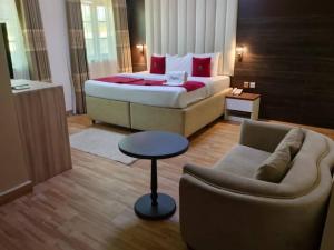 a hotel room with a bed and a couch at Marrisson Residence in Abuja