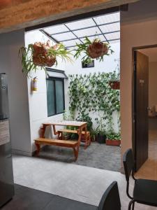 a room with a table and a wall with plants at Envigado tradicion y modernidad in Envigado