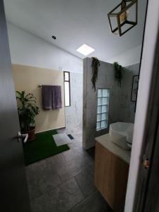 a bathroom with a sink and a toilet and a mirror at Envigado tradicion y modernidad in Envigado +49 photos