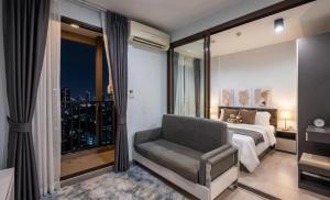 a bedroom with a bed and a chair and a window at Zcape garden by lsqstays in Ban Rangeng +48 photos