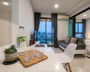 a living room with a table with glasses on it at Zcape garden by lsqstays in Ban Rangeng