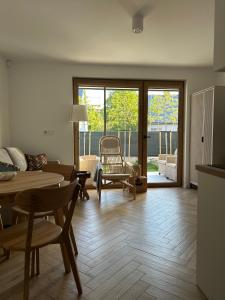 a living room with a table and chairs and a dining room at Brzeg in Kuźnica