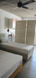 two beds sitting next to each other in a room at Nicole's Cave Studio in Pylos