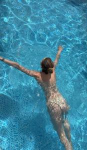 a woman is swimming in a pool of water at Dzvin in Slavske