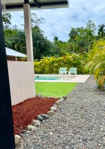 a house with a garden and a swimming pool at Lalola de Puerto in Puerto Viejo