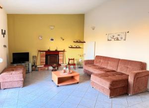 a living room with two couches and a fireplace at Shell-paralia ofriniou in Ofrínion