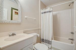 a bathroom with a sink and a toilet and a mirror at Prospect Hill on Main in Waynesville