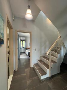 a hallway with stairs leading to a bedroom at Pebble Home in Yialós