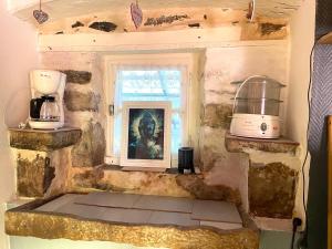 a kitchen with a window and two appliances in it at Le refuge du templier in Plaisance