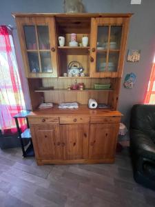 a wooden cabinet in a living room at Le refuge du templier in Plaisance +71 photos