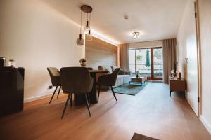 a dining room and living room with a table and chairs at ALPEN STUDIO - moderne Ferienwohnung mit Bergblick & Südterrasse in Bad Hindelang in Bad Hindelang