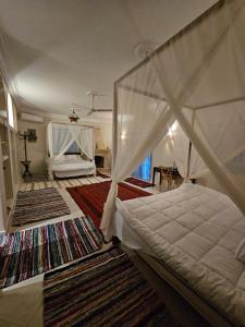 a bedroom with a canopy bed and a rug at Dahshur Pyramids View Inn in Giza