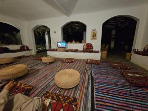 a living room with pillows on the floor and a room with a room at Dahshur Pyramids View Inn in Giza